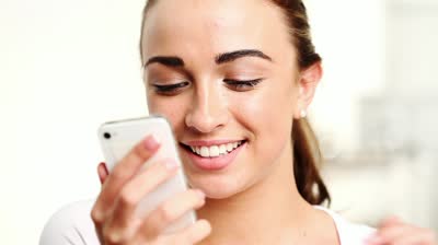 stock-footage-pretty-young-girl-taking-a-photo-of-herself-with-her-smartphone